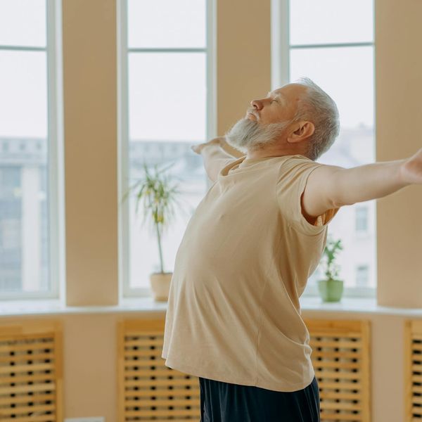 Man in a calm meditative pose after a workout, showing harmony.
